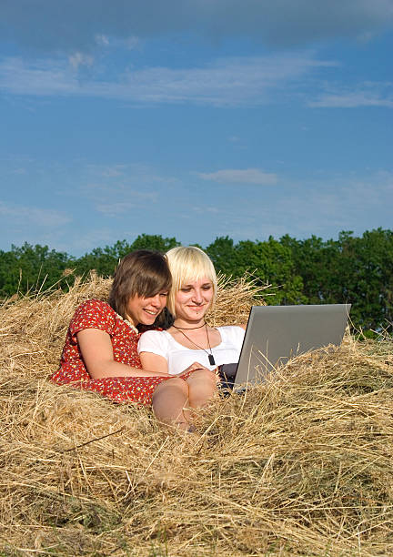 Two Young girl work with laptop stock photo