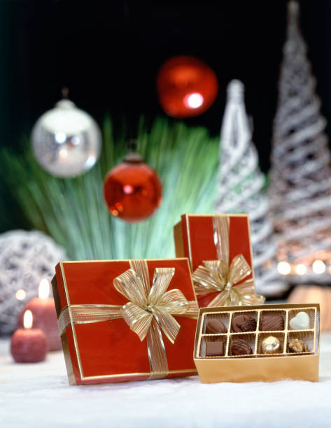istock Luxury gift boxes with golden ribbon and chocolate 1182190426