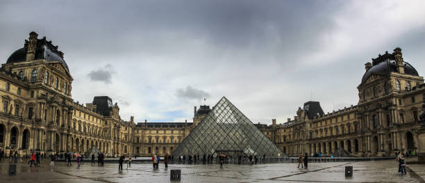 The Louvre Museum France, Paris - April 9, 2013: The Louvre Museum on the stormy rainy day in a winter season musee du louvre stock pictures, royalty-free photos & images