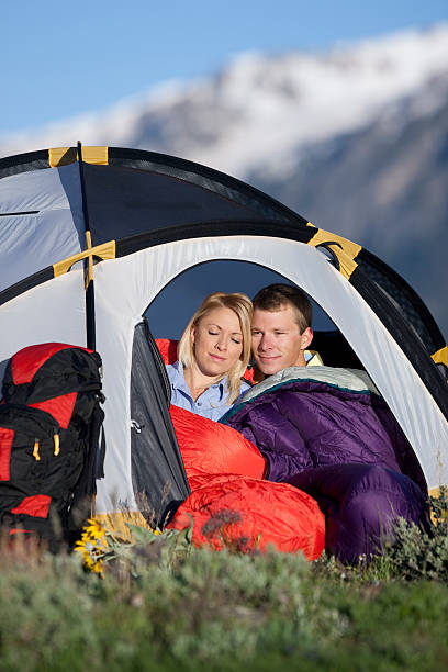 istock Young Couple Sitting Inside Tent With Mountains In Background 118219497