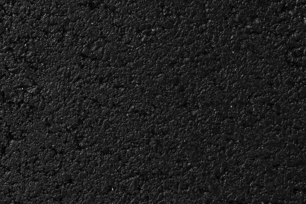istock Wet asphalt texture, material. Black backdrop, grain pavement. Dark grunge surface, background. 1182195082