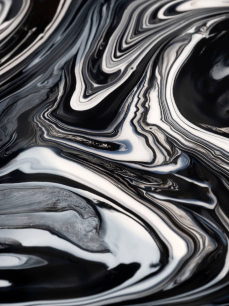 istock Streaks and patterns when mixing white paint with black pigment before staining 1182196356