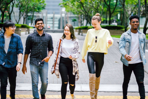 istock Group of People Talking While Walking on The Street 1182196406