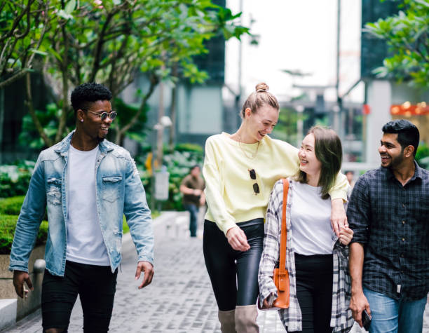 istock Group of People Talking While Walking on The Street 1182196431