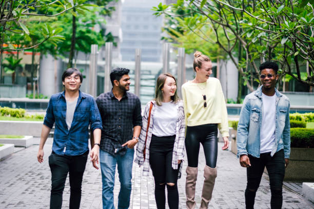istock Group of People Talking While Walking on The Street 1182196443