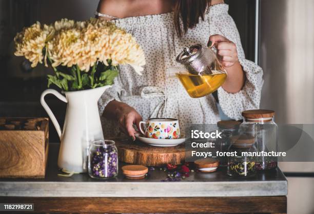 Young Woman Pouring Green Tea From Pot Into Cup Stock Photo - Download Image Now - Tea - Hot Drink, Drinking, Afternoon Tea