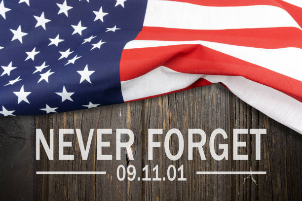 Text Never Forget on American flag background United Stated flag with text Never Forget 9/11 memorial event photos stock pictures, royalty-free photos & images