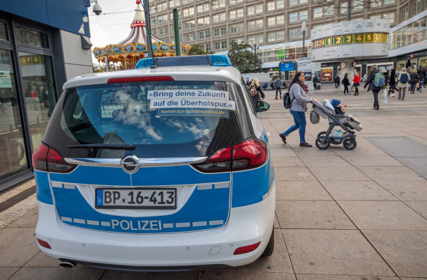 Berlin, Germany, October 2, 2019: Police car with advertisement for becoming a police person in the street at Berlin Alexanderplatz. Alexanderplatz was the center in the old East Berlin and are still a popular place for the berliners