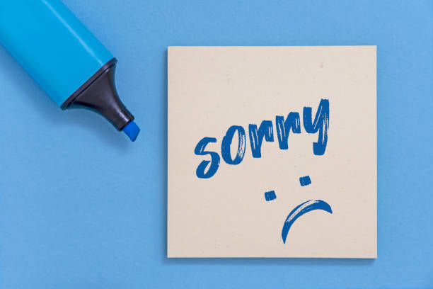 istock Message of apology and sad face on post it. 1182202363