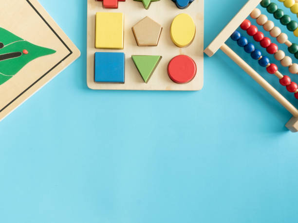 istock kids learning concept with stacking toys on blue table background. 1182202455