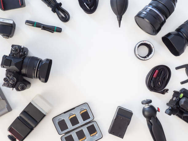 istock top view of work space photographer with digital camera, flash, cleaning kit, memory card, tripod and camera accessory on white table background 1182202471