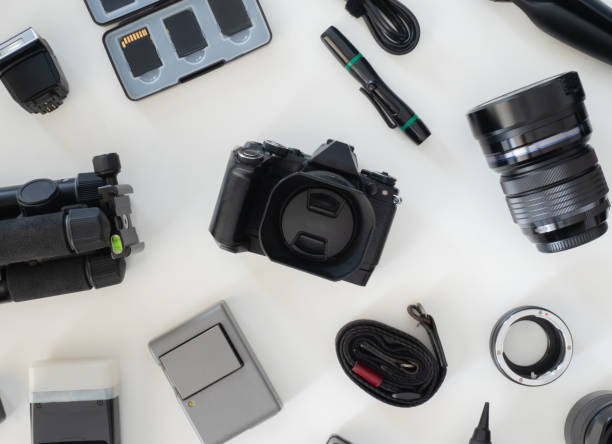 istock top view of work space photographer with digital camera, flash, cleaning kit, memory card, tripod and camera accessory on white table background 1182202472