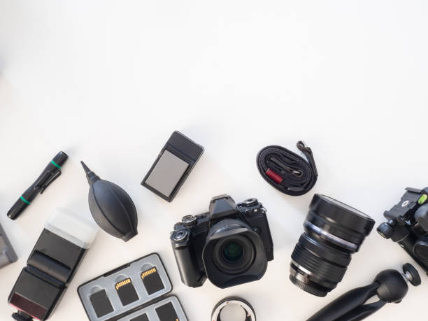 istock top view of work space photographer with digital camera, flash, cleaning kit, memory card, tripod and camera accessory on white table background 1182202494