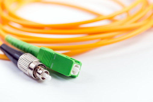 Fiber optic cable link plug connector on white background