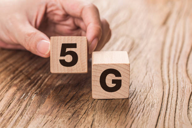 istock 5G (5th Generation) network connecting technology future global. Hand flip wood cube change number 4G to 5G 1182205215
