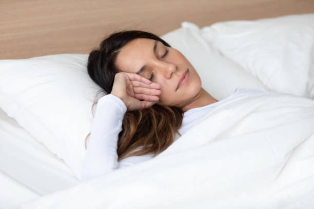 istock Peaceful mixed race young woman sleeping alone in bed. 1182205996