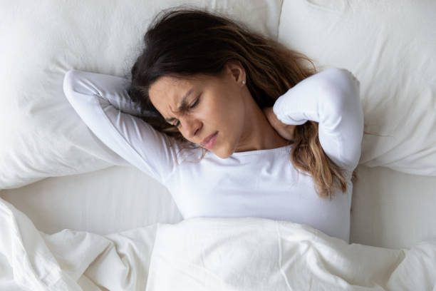 istock Stressed young mixed race woman feeling neck ache after sleep. 1182206000