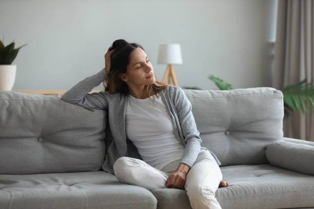 istock Peaceful thoughtful young mixed race woman sitting on cozy sofa. 1182206166
