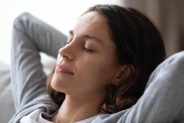 istock Mindful young mixed race girl relaxing on sofa at home. 1182206168