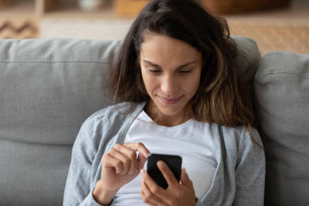 istock Head shot close up young mixed race woman using mobile phone. 1182206271