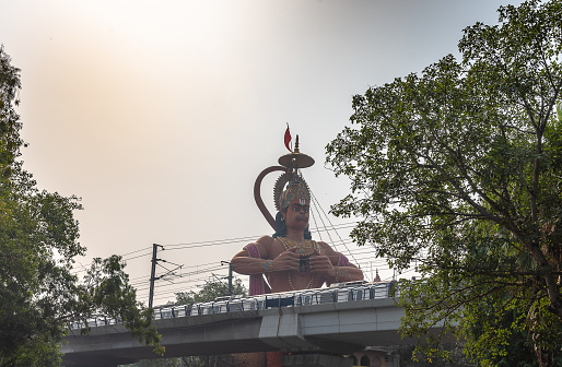 Hanuman temple near Karol Bagh Delhi with giant 108 feet statute of Lord Hanuman with view of Delhi Metro Rail service.