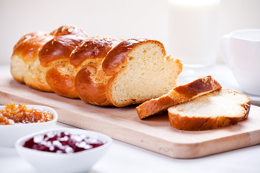Homemade traditional greek braided brioche with almonds