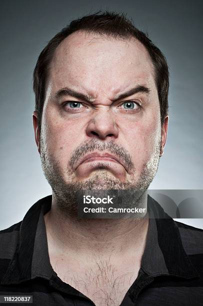 An Unshaven Man Making A Frown With Eyebrows Raised Stock Photo - Download Image Now