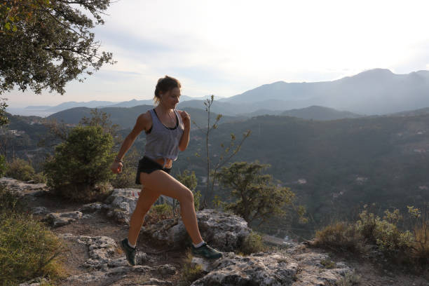 istock Female trail runner traverses ridge crest at sunrise 1182208533