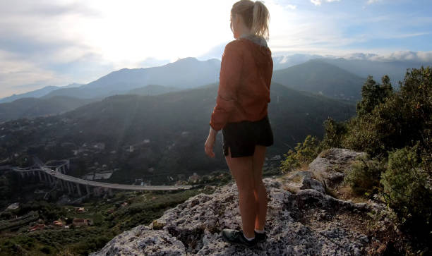istock Female trail runner traverses ridge crest at sunrise 1182208580