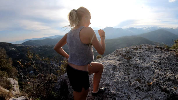 istock Female trail runner traverses ridge crest at sunrise 1182208689