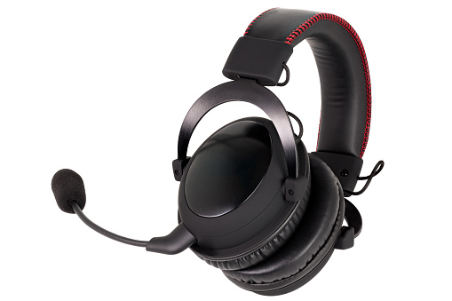 close view of wireless black gaming headphones with microphone isolated on white background.