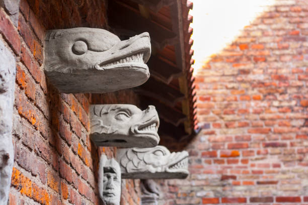 Carvings on bricky wall inside yard of medieval prison tower and torture chamber, today Amber Museum in Gdansk, Poland