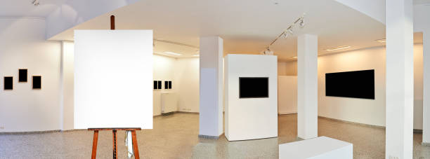 istock Painter's easel and empty canvas frame in a exhibition gallery 1182210771