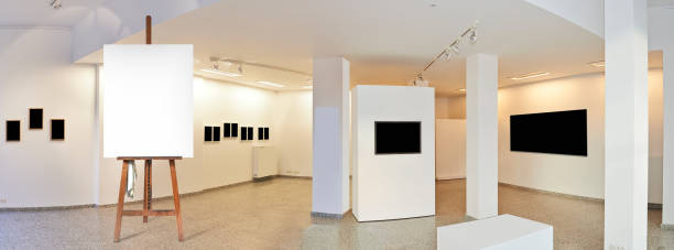 istock Painter's easel and empty canvas frame in a exhibition gallery 1182210907