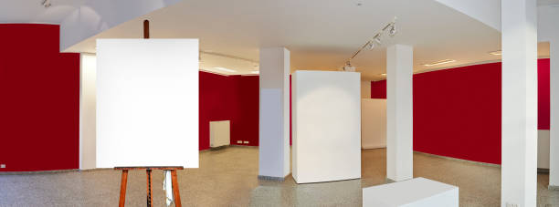 istock Painter's easel and empty canvas frame in a exhibition gallery 1182210948