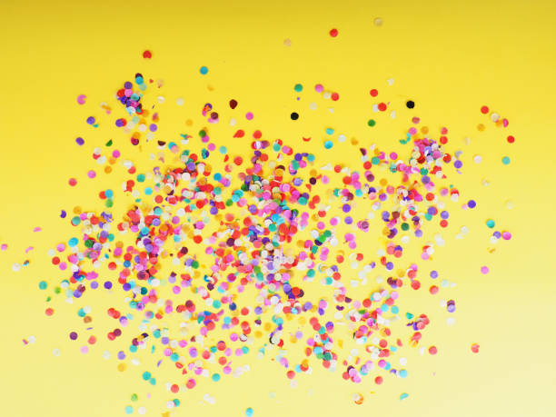istock colorful confetti on yellow background as texture, holiday concept 1182211025