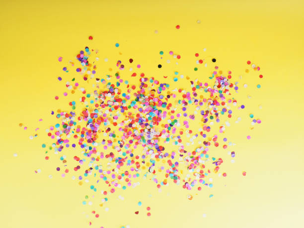istock colorful confetti on yellow background as texture, holiday concept 1182211037