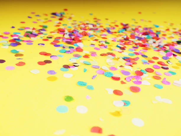 istock colorful confetti on yellow background as texture, holiday concept 1182211040