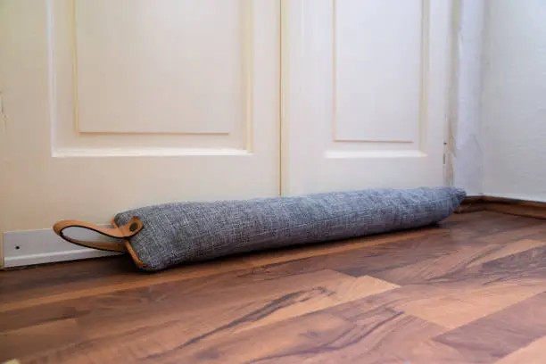 Draft Excluder Under Door Blocking Cold Air From Traveling Around
