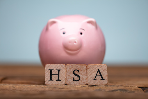 HSA Health Savings Account Wooden Blocks Near Piggybank On Table