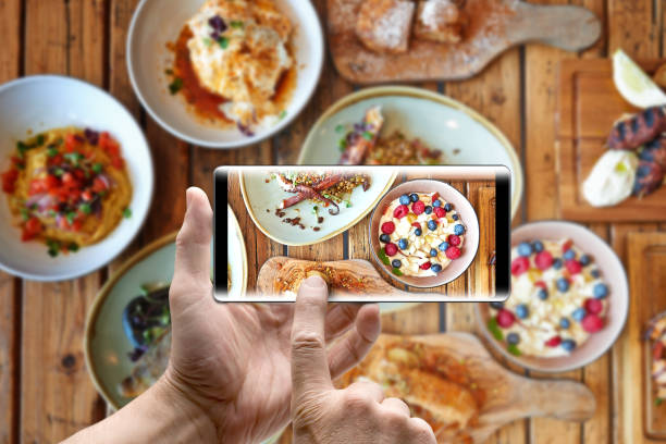 istock Two hands holding a mobile Smartphone and take a picture 1182212152