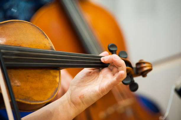 istock Violinist playing violin close up 1182213651
