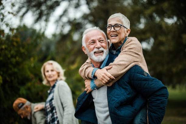 istock Happy senior couple having fun while piggybacking in nature. 1182213947