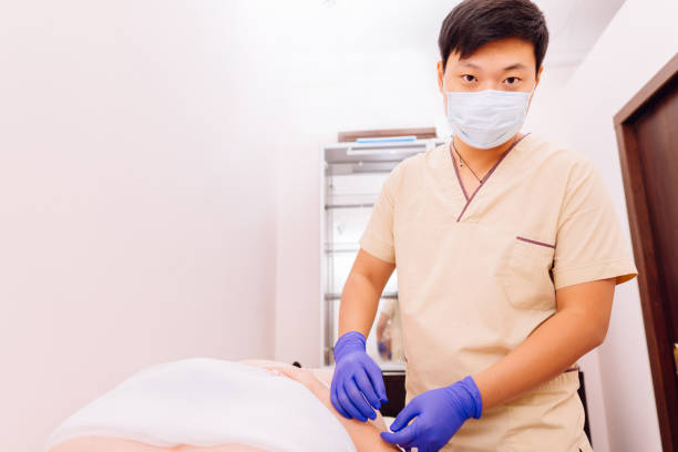 istock Therapist do acupuncture therapy on woman's body 1182214808