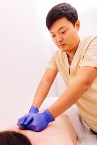 istock Therapist performing Gua Sha massage on woman 1182214854