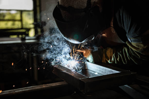 istock Steel worker grinding metal in a workshop. 1182216563