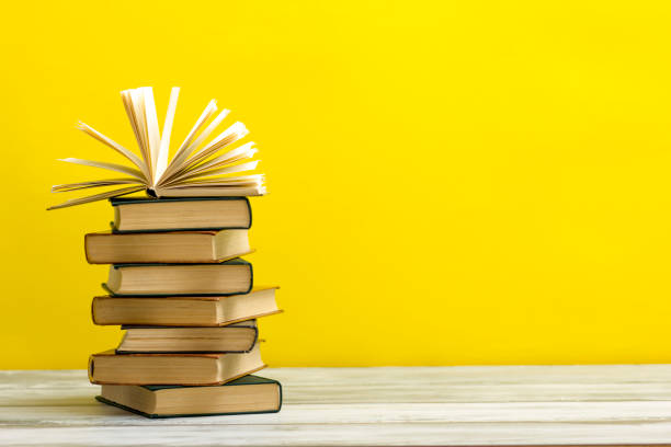 istock Open book, hardback books on wooden table. Back to school. Copy space 1182216673
