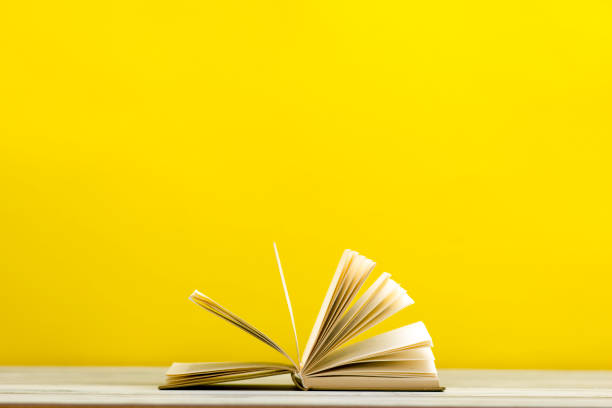 istock Open book, hardback books on wooden table. Back to school. Copy space 1182217263
