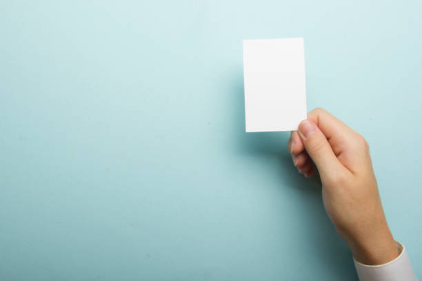 istock Hand holding white business card on white background 1182218361