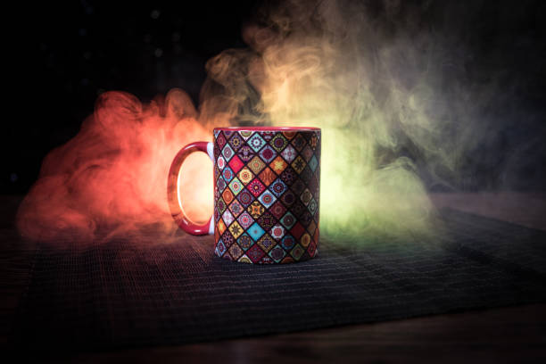 istock Beautiful eastern style textured ceramic cup of coffee (or tea) with smoke over dark toned background. 1182221136